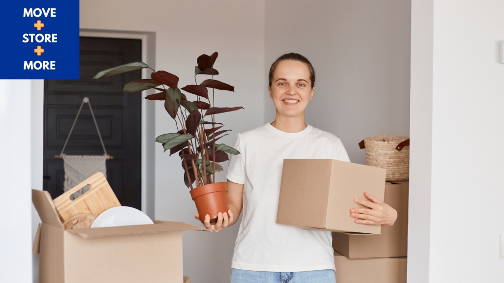 Image of a woman carrying a moving box and a house plant