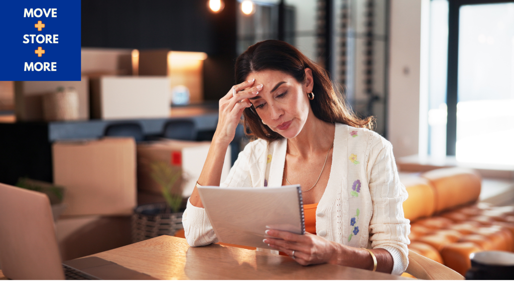Image of woman reading a lease while preparing to move.