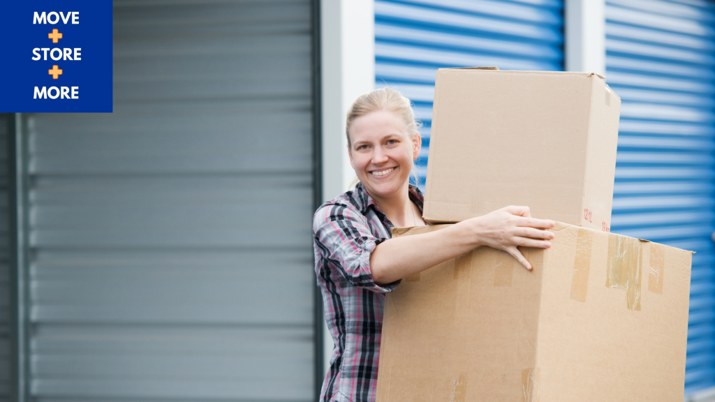 Image of a woman moving packed boxes into a storage unit.