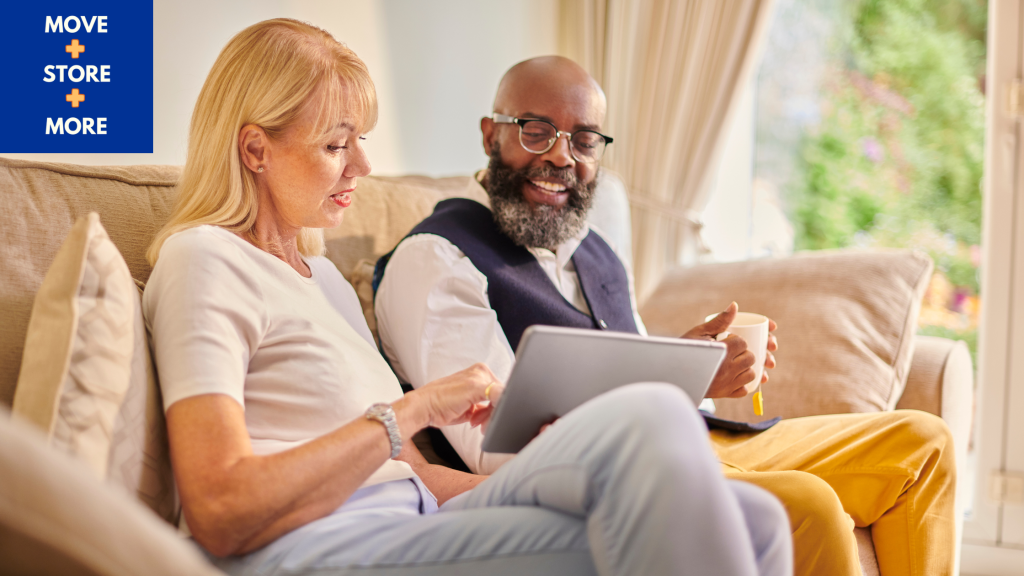 Image of a couple comparing moving quotes at a kitchen table.